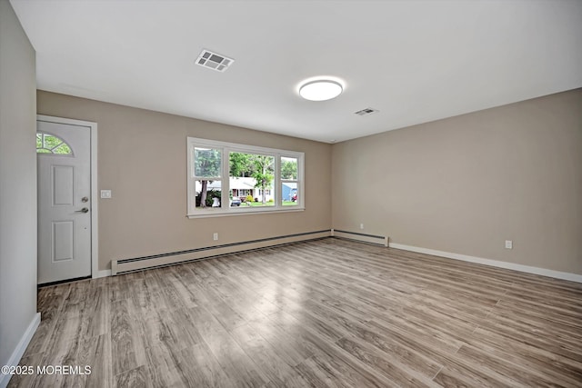 48 Sheepshead Dr, Toms River, NJ 08757 - empty room with baseboard heating and wood finished floors