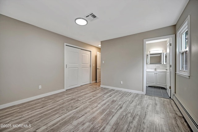 48 Sheepshead Dr, Toms River, NJ 08757 - unfurnished bedroom with a baseboard radiator, light wood-style flooring, ensuite bathroom, and a closet