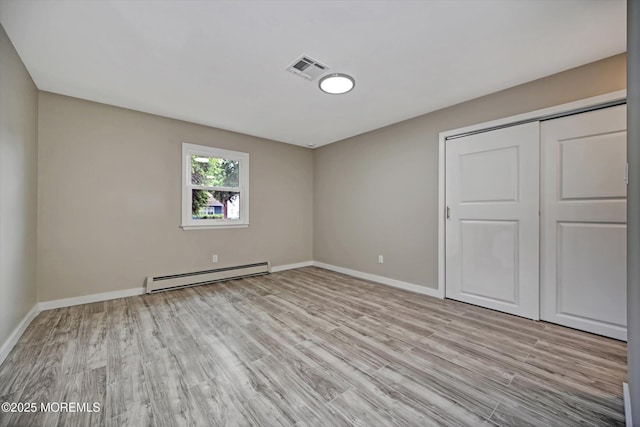 48 Sheepshead Dr, Toms River, NJ 08757 - unfurnished bedroom with a baseboard radiator, light wood finished floors, and a closet