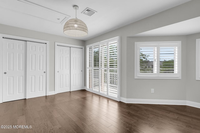 7 Navesink Ct, Long Branch, NJ 07740 - unfurnished bedroom with attic access, two closets, and dark wood-type flooring