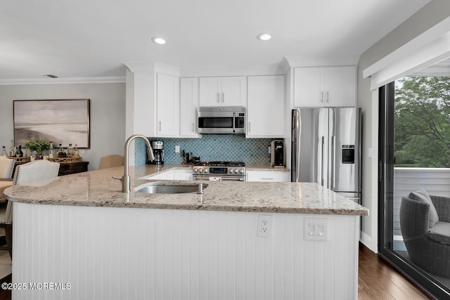 7 Navesink Ct, Long Branch, NJ 07740 - kitchen featuring appliances with stainless steel finishes, light stone counters, a peninsula, ornamental molding, and white cabinets