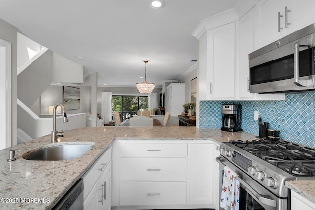 7 Navesink Ct, Long Branch, NJ 07740 - kitchen featuring stainless steel appliances, white cabinets, light stone countertops, tasteful backsplash, and pendant lighting