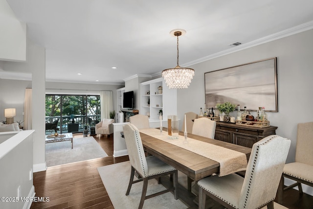 7 Navesink Ct, Long Branch, NJ 07740 - dining area featuring a chandelier, dark wood-style floors, crown molding, and recessed lighting