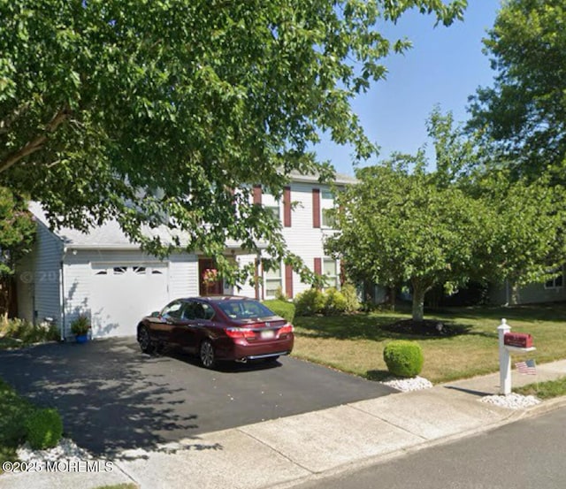 35 Winsted Dr, Howell, NJ 07731 - obstructed view of property featuring driveway, a garage, and a front lawn