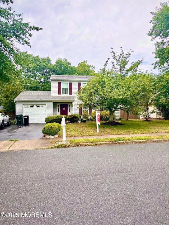 35 Winsted Dr, Howell, NJ 07731 - traditional home with an attached garage, driveway, and a front yard