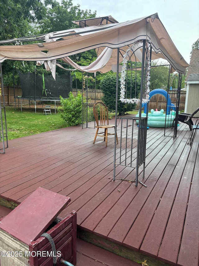 35 Winsted Dr, Howell, NJ 07731 - wooden deck with a trampoline