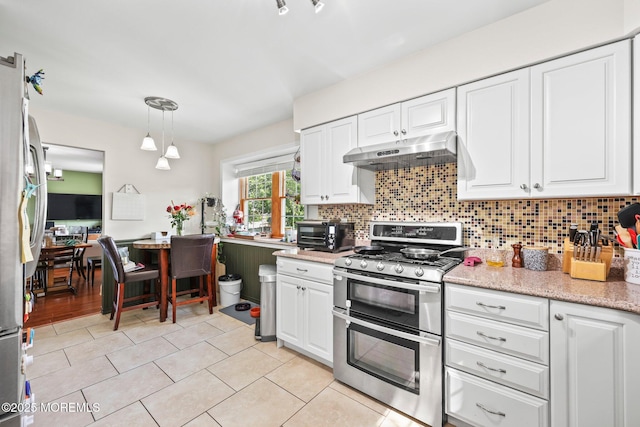 104 Starlight Rd, Howell, NJ 07731 - kitchen with stainless steel appliances, under cabinet range hood, white cabinetry, backsplash, and light tile patterned floors