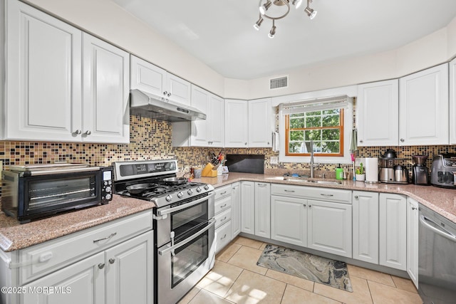 104 Starlight Rd, Howell, NJ 07731 - kitchen featuring stainless steel appliances, under cabinet range hood, white cabinets, and decorative backsplash