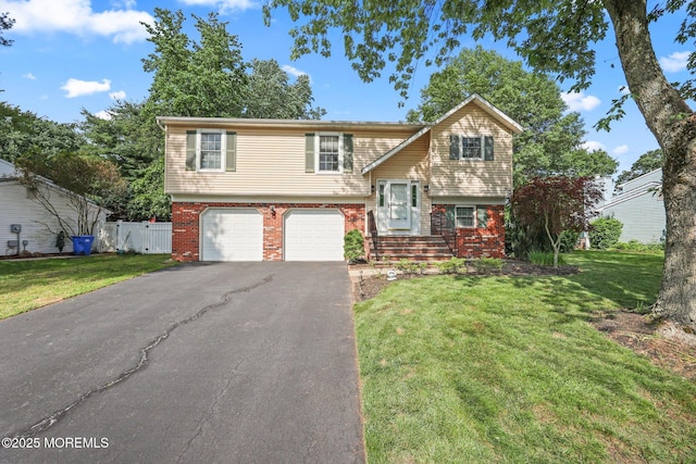 104 Starlight Rd, Howell, NJ 07731 - bi-level home with asphalt driveway, a garage, and brick siding