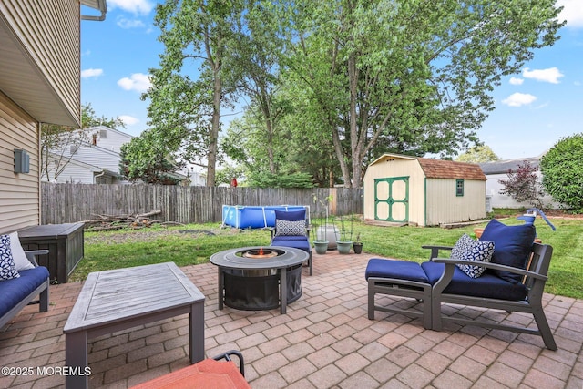 104 Starlight Rd, Howell, NJ 07731 - fenced backyard with a patio, a shed, and an outdoor living space with a fire pit