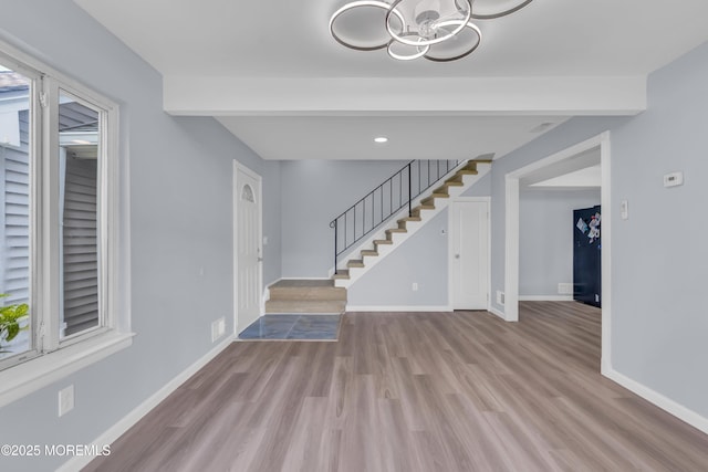 23 Arlene Ct Unit 4103, Brick, NJ 08723 - entrance foyer with a chandelier, stairway, wood finished floors, healthy amount of natural light, and beamed ceiling