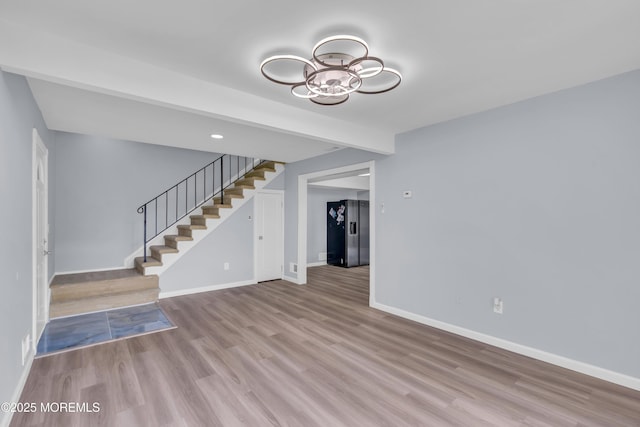 23 Arlene Ct Unit 4103, Brick, NJ 08723 - unfurnished living room with stairway, wood finished floors, and a chandelier