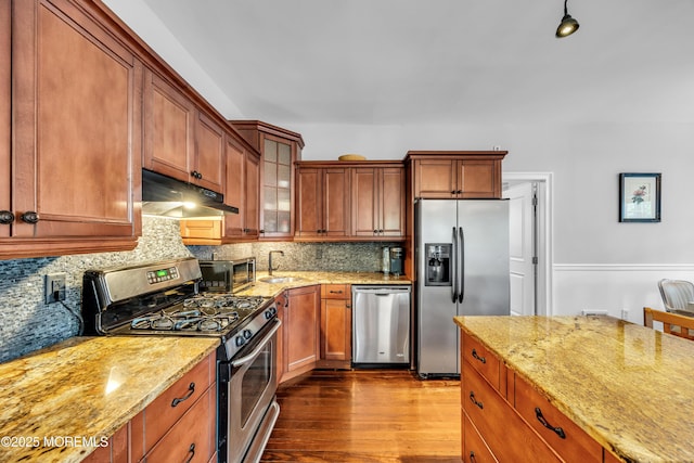 1108 Emory St, Asbury Park, NJ 07712 - kitchen with appliances with stainless steel finishes, under cabinet range hood, light stone counters, and dark wood-style floors