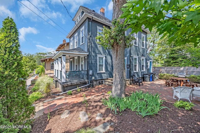 1108 Emory St, Asbury Park, NJ 07712 - view of home's exterior featuring covered porch, a chimney, and a patio