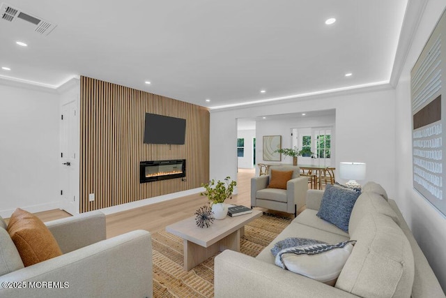 9 Westbrook Dr, Toms River, NJ 08757 - living area featuring recessed lighting, a glass covered fireplace, an accent wall, and light wood-type flooring