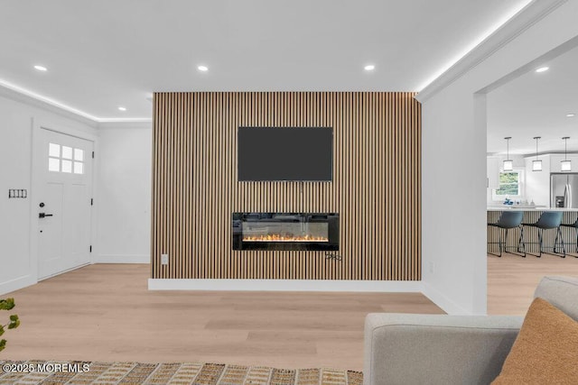 9 Westbrook Dr, Toms River, NJ 08757 - living area with an accent wall, wood finished floors, healthy amount of natural light, recessed lighting, and a glass covered fireplace