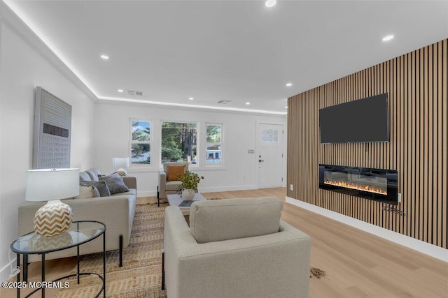 9 Westbrook Dr, Toms River, NJ 08757 - living room featuring a glass covered fireplace, wood finished floors, and recessed lighting