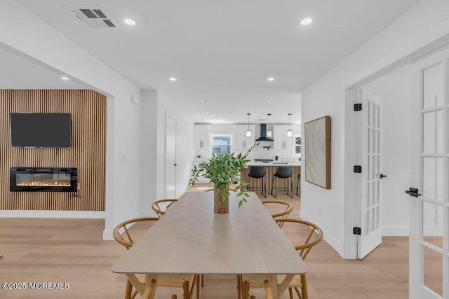 9 Westbrook Dr, Toms River, NJ 08757 - dining area with light wood finished floors, recessed lighting, a glass covered fireplace, and heating unit