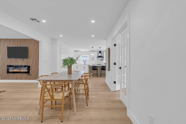 9 Westbrook Dr, Toms River, NJ 08757 - dining space featuring light wood-type flooring, recessed lighting, and a glass covered fireplace