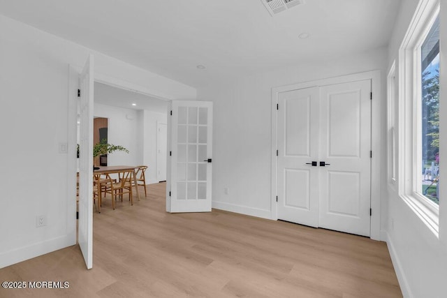 9 Westbrook Dr, Toms River, NJ 08757 - empty room with healthy amount of natural light, light wood-type flooring, and french doors