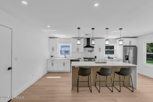 9 Westbrook Dr, Toms River, NJ 08757 - kitchen featuring stainless steel appliances, wall chimney range hood, tasteful backsplash, white cabinets, and recessed lighting