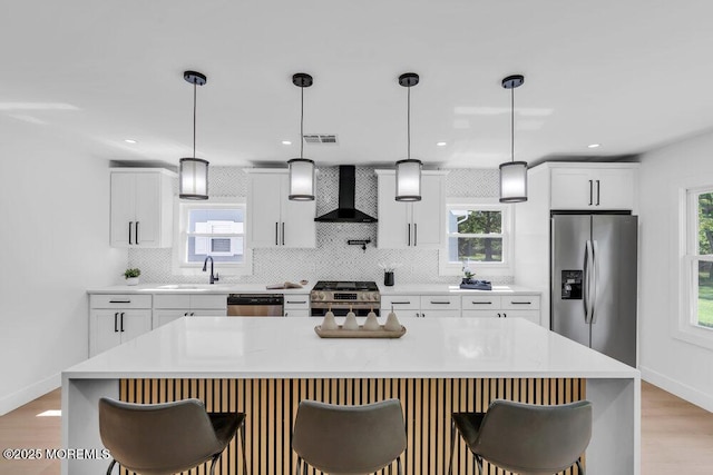 9 Westbrook Dr, Toms River, NJ 08757 - kitchen featuring appliances with stainless steel finishes, wall chimney exhaust hood, a kitchen bar, backsplash, and recessed lighting