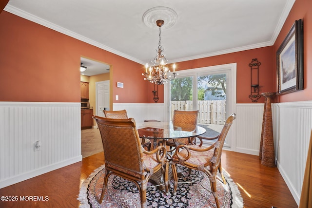 74 Kingsley Way, Freehold, NJ 07728 - dining room featuring a wainscoted wall, crown molding, light wood-type flooring, and a chandelier