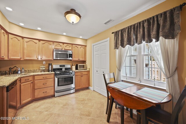 74 Kingsley Way, Freehold, NJ 07728 - kitchen with stainless steel appliances, light stone countertops, light tile patterned floors, and recessed lighting