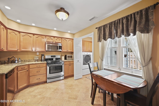 74 Kingsley Way, Freehold, NJ 07728 - kitchen with stainless steel appliances, washer / clothes dryer, light stone countertops, light tile patterned floors, and recessed lighting