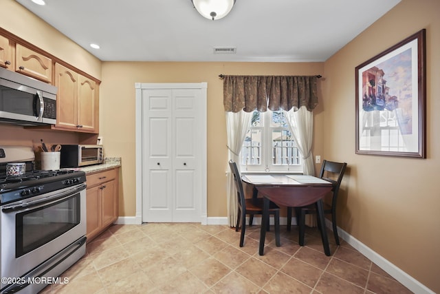 74 Kingsley Way, Freehold, NJ 07728 - kitchen featuring stainless steel appliances, light countertops, light brown cabinets, recessed lighting, and light tile patterned floors