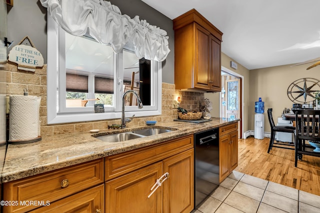 702 Saint Louis Ave, Point Pleasant Beach, NJ 08742 - kitchen featuring black dishwasher, healthy amount of natural light, light stone counters, and brown cabinets
