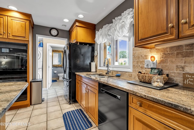 702 Saint Louis Ave, Point Pleasant Beach, NJ 08742 - kitchen featuring black appliances, estacked washer and dryer, backsplash, light stone counters, and light tile patterned floors