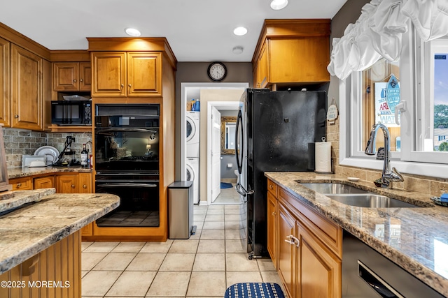 702 Saint Louis Ave, Point Pleasant Beach, NJ 08742 - kitchen featuring black appliances, stacked washer / dryer, brown cabinets, light stone counters, and recessed lighting