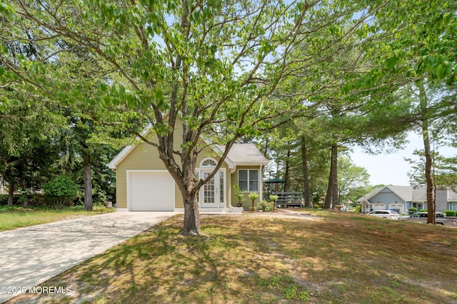 19 Cedar Ave, Manahawkin, NJ 08050 - view of front of home featuring an attached garage, concrete driveway, and french doors