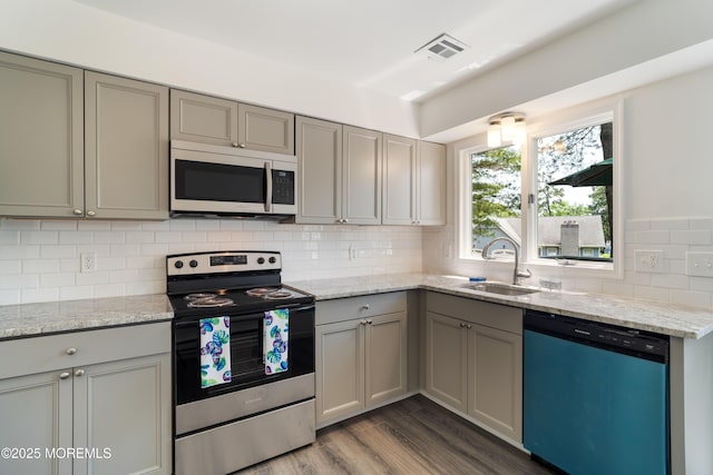 19 Cedar Ave, Manahawkin, NJ 08050 - kitchen with dishwasher, stainless steel electric range, gray cabinets, tasteful backsplash, and wood finished floors