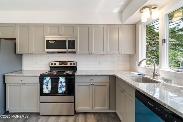 19 Cedar Ave, Manahawkin, NJ 08050 - kitchen with stainless steel appliances, gray cabinets, backsplash, light stone countertops, and dark wood-style flooring