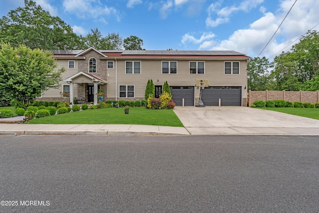 1159 County Line Rd E, Lakewood, NJ 08701 - view of front of house with stone siding, an attached garage, roof mounted solar panels, and concrete driveway