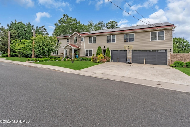 1159 County Line Rd E, Lakewood, NJ 08701 - view of front of house featuring an attached garage, solar panels, driveway, and a front lawn
