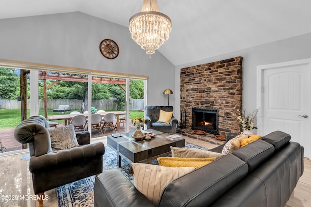 1159 County Line Rd E, Lakewood, NJ 08701 - living area with high vaulted ceiling, a chandelier, a brick fireplace, and wood finished floors