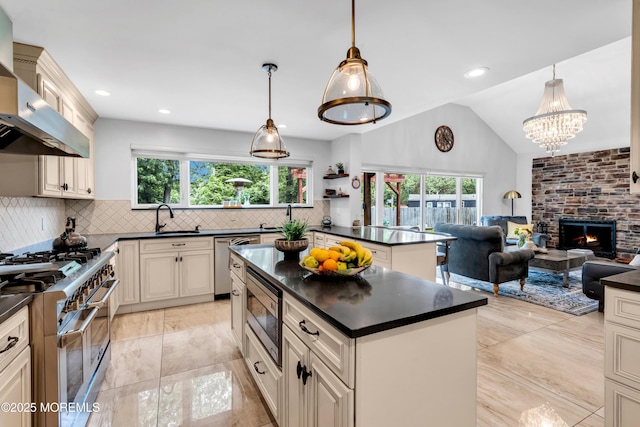 1159 County Line Rd E, Lakewood, NJ 08701 - kitchen with stainless steel appliances, dark countertops, extractor fan, cream cabinetry, and lofted ceiling