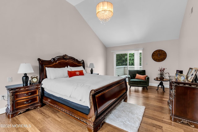 1159 County Line Rd E, Lakewood, NJ 08701 - bedroom featuring vaulted ceiling, wood finished floors, and a chandelier