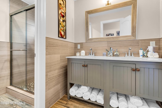 1159 County Line Rd E, Lakewood, NJ 08701 - bathroom with double vanity, a stall shower, and tile walls