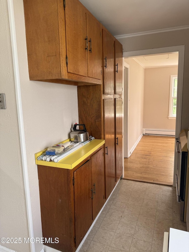 630 Overton Pl, Long Branch, NJ 07740 - kitchen featuring crown molding, baseboard heating, brown cabinetry, and light countertops
