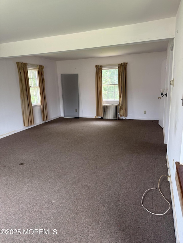 630 Overton Pl, Long Branch, NJ 07740 - spare room with radiator, dark carpet, and plenty of natural light