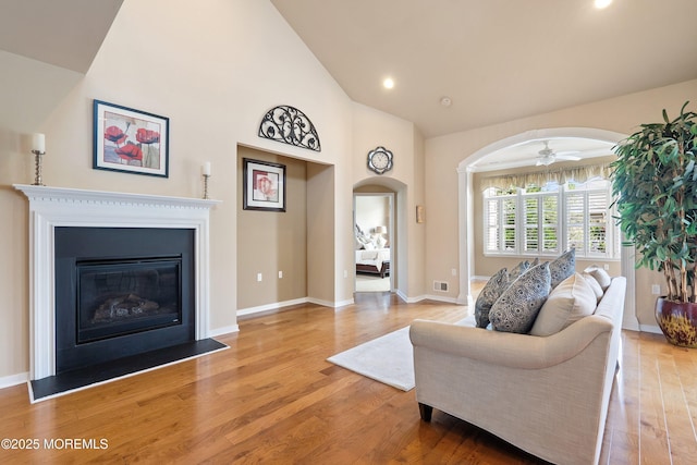 19 E Francesa Ct, Farmingdale, NJ 07727 - living room featuring light wood finished floors, arched walkways, a glass covered fireplace, ceiling fan, and recessed lighting