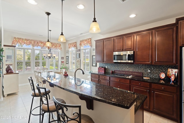 19 E Francesa Ct, Farmingdale, NJ 07727 - kitchen featuring stainless steel appliances, light tile patterned flooring, backsplash, dark stone counters, and decorative light fixtures
