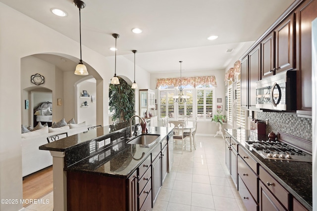19 E Francesa Ct, Farmingdale, NJ 07727 - kitchen with appliances with stainless steel finishes, dark stone counters, tasteful backsplash, dark brown cabinetry, and recessed lighting