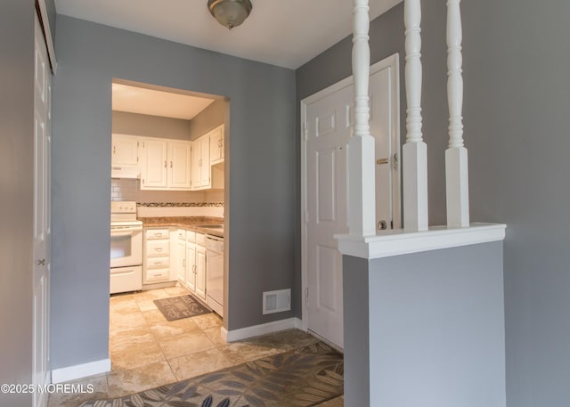 304 Wellington Pl, Aberdeen, NJ 07747 - kitchen with white appliances, backsplash, white cabinets, light countertops, and under cabinet range hood