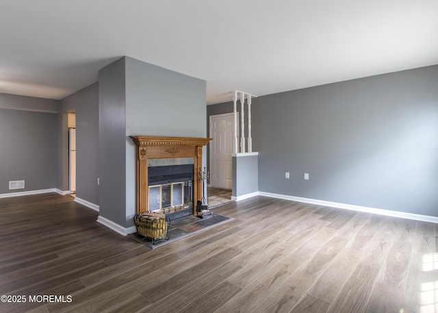 304 Wellington Pl, Aberdeen, NJ 07747 - unfurnished living room with dark wood-style flooring and a fireplace