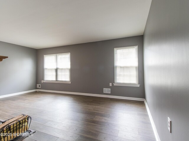 304 Wellington Pl, Aberdeen, NJ 07747 - empty room featuring healthy amount of natural light and wood-type flooring